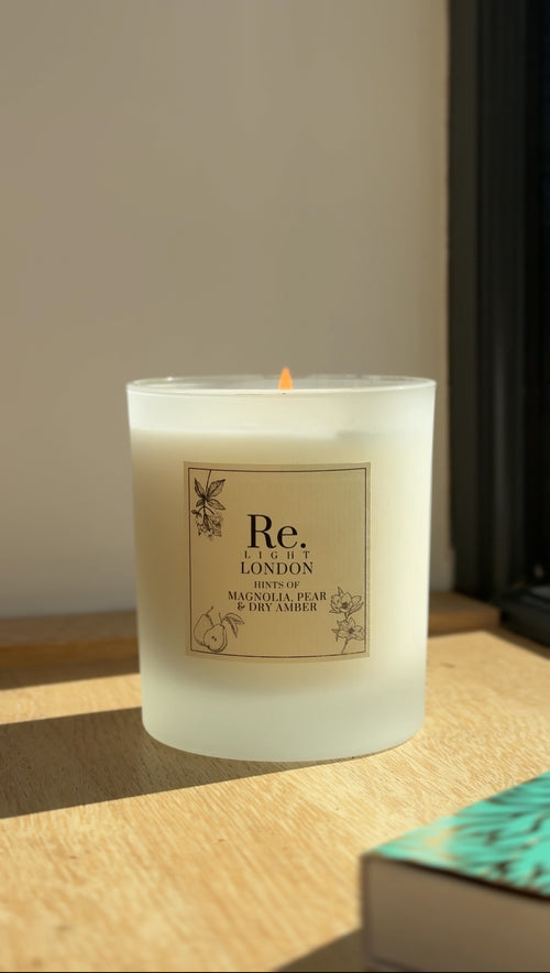 Candle with 'Re. Light London' label on a wooden surface