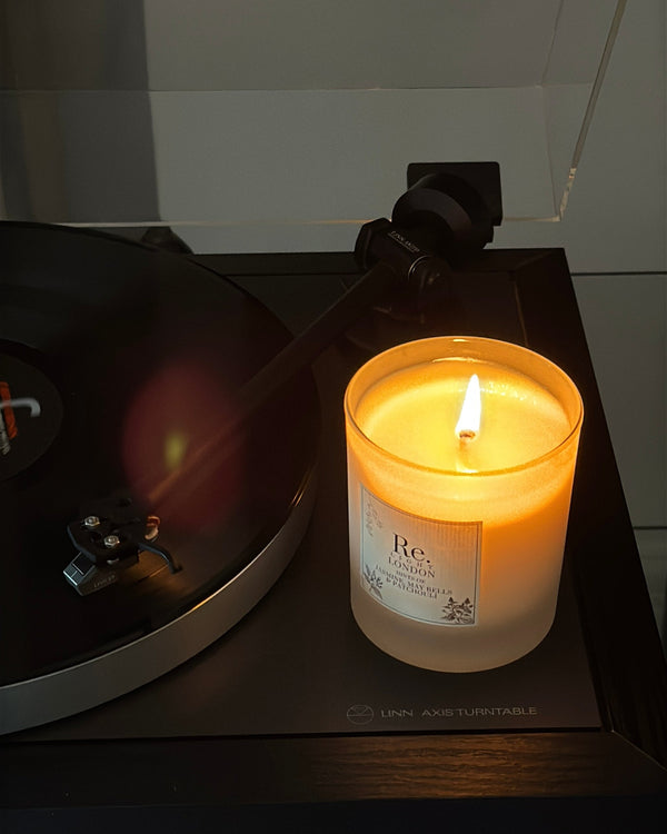 Jazz candle glowing on a turntable with a dark background